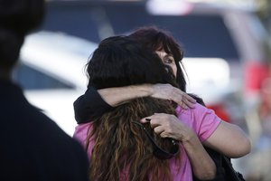 eresa Hernandez, facing camera, is comforted by a woman as she arrives at a social services center in San Bernardino, Calif., where one or more gunmen opened fire, shooting multiple people on Wednesday, Dec. 2, 2015.