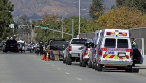 Law enforcement members line up near the the site of a mass shooting on Wednesday, Dec. 2, 2015 in San Bernardino, Calif.