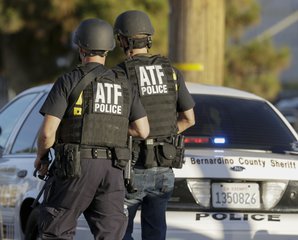 Authorities search an area near where police stopped a suspected vehicle in San Bernardino, Calif., Wednesday, Dec. 2, 2015, following a shooting that killed multiple people at a social services center for the disabled.