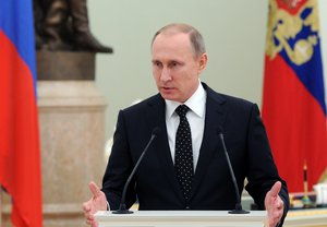 Russian President Vladimir Putin speaks, during a meeting with Russian military personnel presented with awards for the roles they played in Russia's military action in Syria, at the Kremlin in Moscow, Russia, Thursday, Dec. 3, 2015.