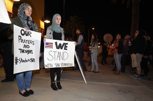 People arrive for a candlelight vigil at San Manuel Stadium, Thursday, Dec. 3, 2015, in San Bernardino, Calif for multiple victims of a shooting that took place at a holiday banquet on Wednesday.