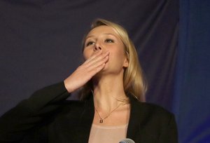 Far right National Front party regional leader for southeastern France, Marion Marechal-Le Pen blows a kiss to supporters , at a meeting with supporters, after the first round of the regional elections, in Carpentras, southern France, Sunday, Dec. 6, 2015.