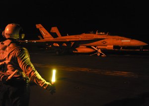 An F/A-18F Super Hornet assigned to the Checkmates of Strike Fighter Squadron 211 prepares to launch from the flight deck aboard the aircraft carrier USS Theodore Roosevelt to conduct  strike operations in Iraq and Syria as directed, Arabian Gulf, 2 October, 2015.