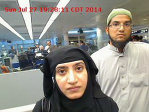 This July 27, 2014 photo provided by U.S. Customs and Border Protection shows Tashfeen Malik, left, and Syed Farook, as they passed through O'Hare International Airport in Chicago.