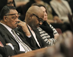 Rev. Jesse Jackson left, listens as Chicago Mayor Rahm Emanuel speaks during a special City Council meeting that he called to discuss a police abuse scandal Wednesday, Dec. 9, 2015, in Chicago.