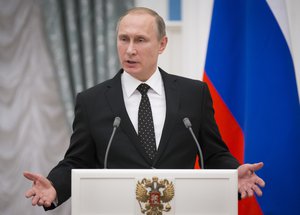 Russian President Vladimir Putin gestures while speaking to the media during his and France's President Francois Hollande news conference following the talks in Moscow, Russia, Thursday, Nov. 26, 2015.