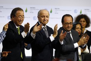 French President Francois Hollande, right, French Foreign Minister and president of the COP21 Laurent Fabius, center, and United Nations Secretary General Ban ki-Moon applaud after the final conference at the COP21, the United Nations conference on climate change, in Le Bourget, north of Paris, Saturday, Dec.12, 2015.