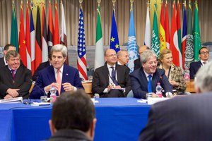 U.S. Secretary of State John Kerry sits with Italian Foreign Minister Paolo Gentiloni at the Italian Foreign Ministry in Rome, Italy, on December 13, 2015, at the outset of a meeting with their regional counterparts about the future of Libya.