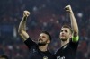 Arsenal's scorer Olivier Giroud, left, Per Mertesacker, center, and Theo Walcott  wave to their fans after the Champions League Group F soccer match between Olympiakos and Arsenal at Georgios Karaiskakis stadium in Piraeus port, near Athens, Wednesday, Dec. 9, 2015. Arsenal won 3-0. (AP Photo/Thanassis Stavrakis)