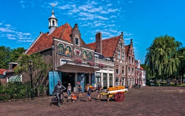 This photograph of an Edam cheese factory, was taken in the Village of Edam in Holland in July 2015. The local children are on a school assignment.