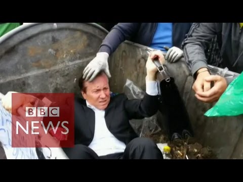 Ukrainian politician 'thrown' into a rubbish bin by angry mob - BBC News