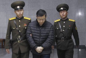 Hyeon Soo Lim, center, who pastors the Light Korean Presbyterian Church in Toronto, is escorted to his sentencing in Pyongyang, North Korea, Wednesday, Dec. 16, 2015.