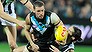 Travis Boak of the Power is tackled by Brodie Grundy of the Magpies.