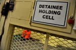 File - A detainee sits in a holding cell at the Detention Facility in Parwan, Afghanistan, Aug. 23, 2010.