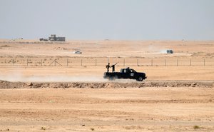 File - Sunni volunteer tribal fighters patrol in support for the Iraqi security forces in fully liberating the city of Ramadi, Iraq, from Islamic State group militants, as they leave Ramadi, the capital of Iraq's Anbar province, 70 miles (115 kilometers) west of Baghdad, Sunday, Oct. 11, 2015.