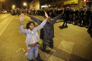 Protesters demonstrate ahead of a 10 p.m. curfew Wednesday, April 29, 2015, in Baltimore. The curfew was imposed after unrest in Baltimore over the death of Freddie Gray while in police custody.