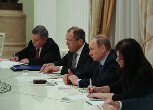 U.S. Secretary of State John Kerry and his advisers sit across from Russian President Vladimir Putin and Russian Foreign Minister Sergey Lavrov before their meeting at the Kremlin in Moscow, Russia, on December 15, 2015.