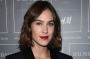 Alexa Chung achieves a timeless look with this double-breasted, brass-buttoned black jacket.