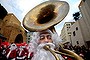 Lebanese men and women wearing Santa Claus costumes play music during a Christmas event, in downtown Beirut, Lebanon, Saturday, Dec. 19, 2015. (AP Photo/Hussein Malla)