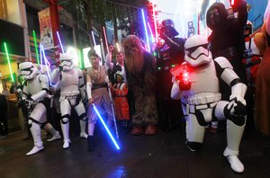 Fans dressed as Star Wars characters parade outside a movie theater showing "Star Wars: The Force Awakens" Saturday, Dec. 19, 2015, in Taipei, Taiwan.