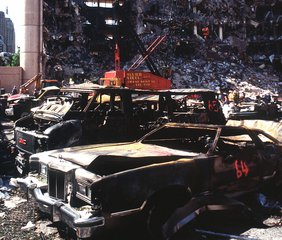 The bombed remains of automobiles with the bombed Federal Building in the background, Oklahoma City, 19 April, 1995. Timothy McVeigh was found guilty of the attack and executed by lethal injection in 2001.