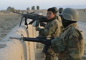 File - Afghan National Army (ANA) soldiers provide security during a joint combat patrol mission in Sarwar Kariz, Afghanistan, Nov. 7, 2009.