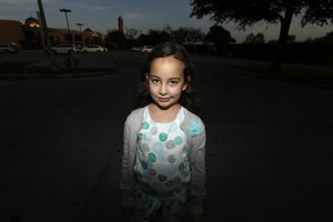 Sofia Yassini, 8, poses for a photo outsider a mosque in Richardson, Texas, Friday, Dec. 11, 2015.