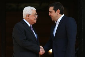 Greek Prime Minister Alexis Tsipras, right, shakes hands with Palestinian President Mahmoud Abbas before their meeting in Athens, on Monday, Dec. 21, 2015. Abbas is in Greece on a two-day official visit.