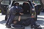 Police search a vehicle as part of what the AFP described as the largest childcare welfare fraud of its kind the force has uncovered this year.