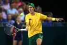 Thanasi Kokkinakis hits a forehand return.