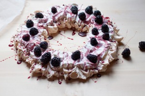 Emiko Davies' Christmas pavlova wreath decorated with mulled wine syrup and blackberries.