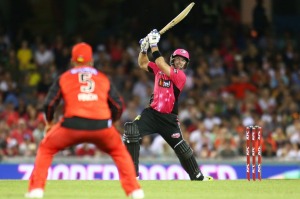 In control: Michael Lumb belts a six as Renegades' skipper Aaron Finch watches on.