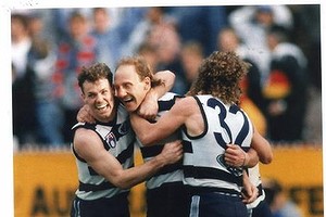 Gary Ablett is besieged by teammates Michael Mansfield (left) and Garry Hocking (right) after kicking the match winning goal.