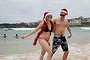 Amy Frampton and Dan Brown from the UK enjoy the water at Bondi Beach on Christmas Day in Sydney.