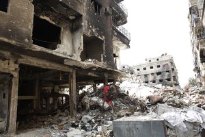 File - Rubble and heavy damage remain on a deserted street during a government escorted visit to Yarmouk refugee camp in Damascus, Syria, Thursday, April 9, 2015