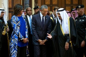 File - President Barack Obama and First Lady Michelle Obama walk with King Salman bin Abdulaziz of Saudi Arabia at Erga Palace in Riyadh, Saudi Arabia, Jan. 27, 2015.