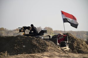 Iraqi Security forces with national flag enter downtown Ramadi, 70 miles (115 kilometers) west of Baghdad, Iraq, Sunday, Dec. 27, 2015. Islamic State fighters are putting up a tough fight in the militant-held city of Ramadi, slowing down the advance of Iraqi forces, Gen. Ismail al-Mahlawi, head of the Anbar military operations, said Sunday.