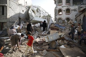 People inspect the rubble of houses destroyed by a Saudi-led airstrike in Sanaa, Yemen, Tuesday, Sept. 8, 2015.