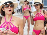 146286, Bethenny Frankel shows off her slim figure in a bright pink bikini on the beach in Miami. The 'Real Housewives of New York City' star spent the afternoon on the beach with a friend and her son before headed back inside. Bethenny appeared engrossed in her phone as she headed back to her hotel. Miami, Florida - Sunday December 27, 2015. Photograph: Brett Kaffee, ¬© Pacific Coast News. Los Angeles Office: +1 310.822.0419 sales@pacificcoastnews.com FEE MUST BE AGREED PRIOR TO USAGE