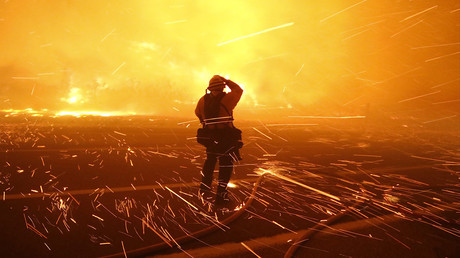 Fire photographer Tod Sudmeier gets hit with flying embers from strong winds at the Solimar brush fire that started early Saturday morning in Ventura County, California December 26, 2015. © Gene Blevins 