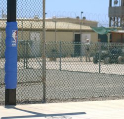 File - A basketball court stands in the center of Camp 4, the medium-security camp within Camp Delta at Naval Station Guantanamo Bay, Cuba. This camp also has a volleyball court and large recreation areas for the detainees.