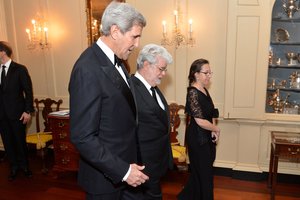 File - U.S. Secretary of State John Kerry chats with 2015 Kennedy Center Honors recipient director/producer George Lucas at the Kennedy Center Honors Dinner at the U.S. Department of State in Washington, D.C., on December 5, 2015.