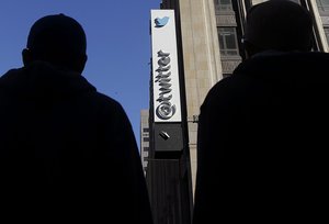 In this Nov. 4, 2013, file photo, pedestrians cross the street in front of Twitter headquarters in San Francisco. Twitter is setting modest goals to diversify its workforce while it fights a proposed class-action lawsuit that says the online messaging service discriminates against its female employees.