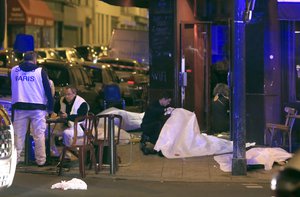 Victims lay on the pavement outside a Paris restaurant, Friday, Nov. 13, 2015.