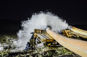 Water is pumped back over the Valley Park levee on the Meramec River in Missouri, Dec. 31, 2015.