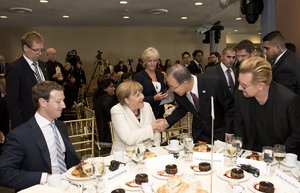 File - Secretary-General Ban Ki-moon (centre) shakes hands with Angela Merkel, Chancellor of Germany, at the United Nations Private Sector Forum 2015, organized by UN Global Compact.