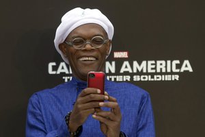 File - Actor Samuel L. Jackson takes a photo with his mobile phone as he attends a publicity event ahead of the April release of his movie "Captain America: The Winter Soldier" in Beijing Monday, March 24, 2014.