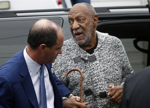 Comedian Bill Cosby is helped as he arrives for a court appearance in Elkins Park, Pa., Wednesday, Dec. 30, 2015.