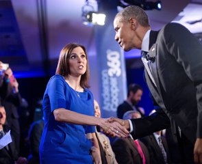 President Barack Obama, right, walks over to greet Taya Kyle, left, widow of U.S. Navy SEAL Chris Kyle, during a commercial break at a CNN televised town hall meeting at George Mason University in Fairfax, Va., Thursday, Jan. 7, 2016.