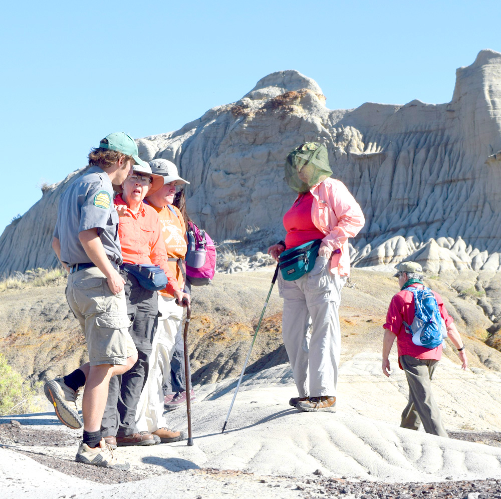 Part of our field trip group discusses Centrosaur Bone Bed 43 during our guided hike at Dinosaur Provincial Park, Alberta.